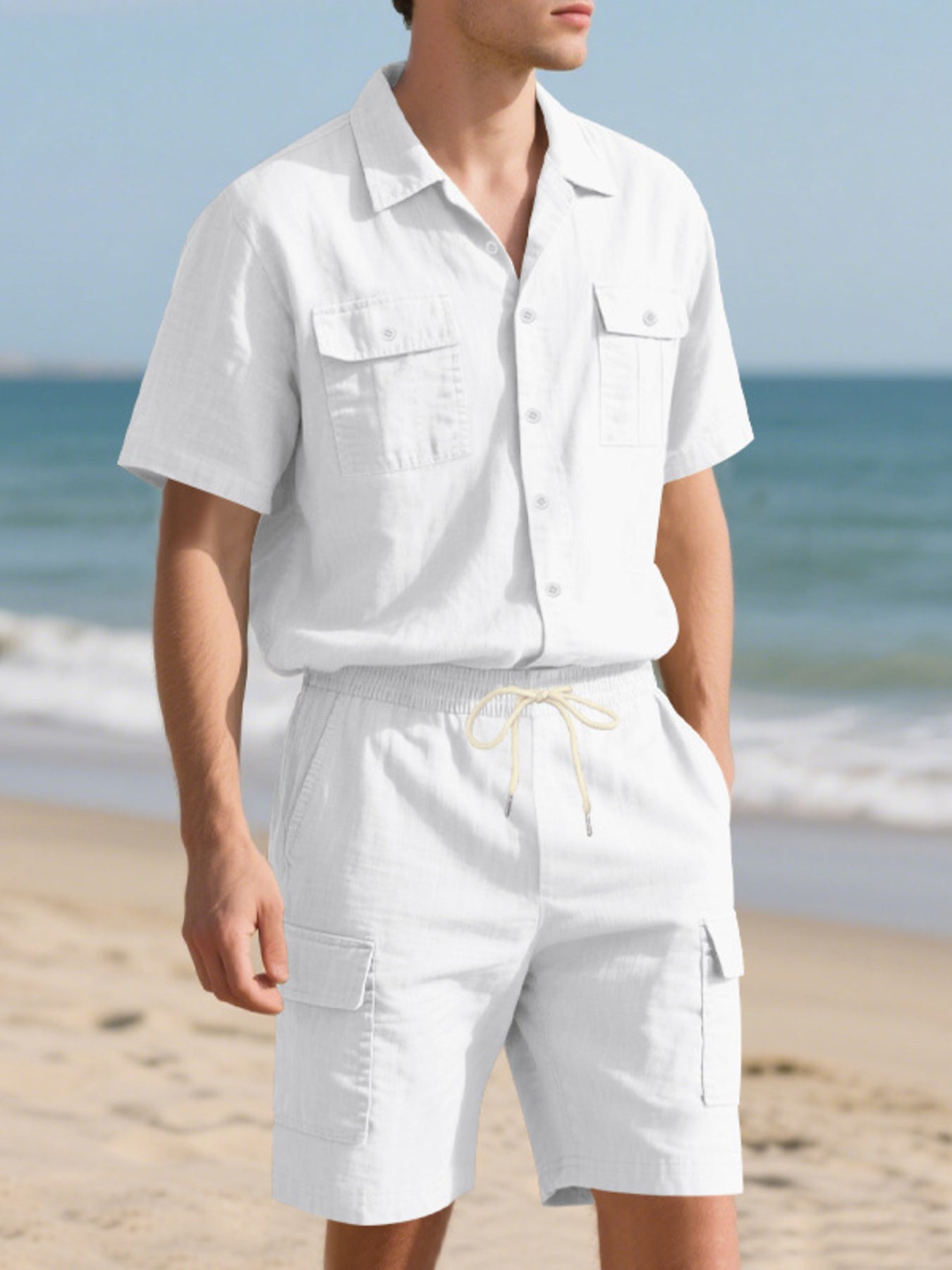 White relaxed-fit button-up shirt with chest pockets and drawstring shorts with cargo pockets.