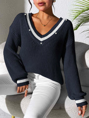 Dark navy V-neck knit sweater with white stripe details on neckline and cuffs.