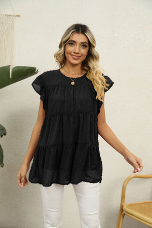 Black Swiss dot tiered blouse with flutter sleeves and round neckline.