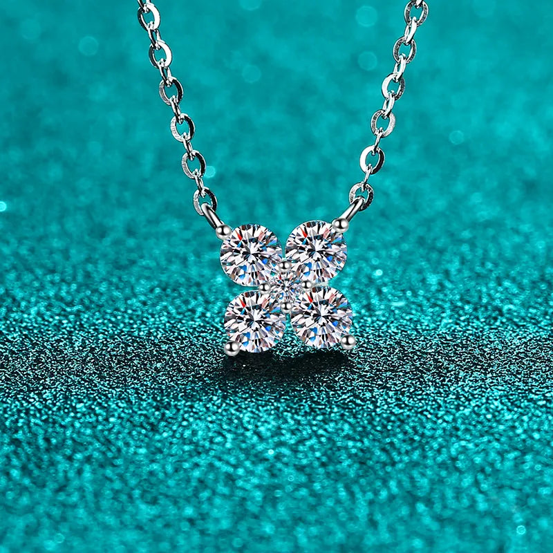 Silver four-stone moissanite clover necklace with delicate chain.