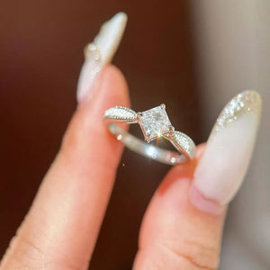 Sterling silver ring with princess cut moissanite and diamond accents