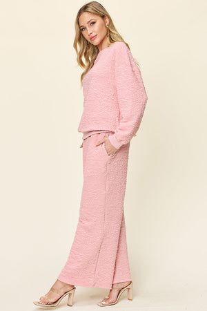 Textured lounge set in Dusty Pink with wide leg pants and crewneck sweatshirt.