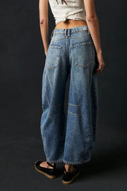 Light blue denim barrel leg jeans with paneled detail and button closure.
