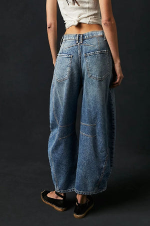 Light blue denim barrel leg jeans with paneled detail and button closure.