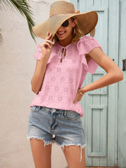 Blush pink eyelet blouse with ruffle sleeves and keyhole tie neck.
