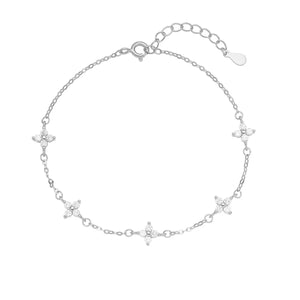 Silver charm bracelet with delicate four-leaf clover charms and crystal accents.