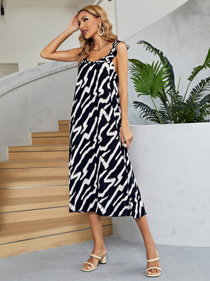 Graphic print midi dress in black and white with tie straps and tiered skirt.