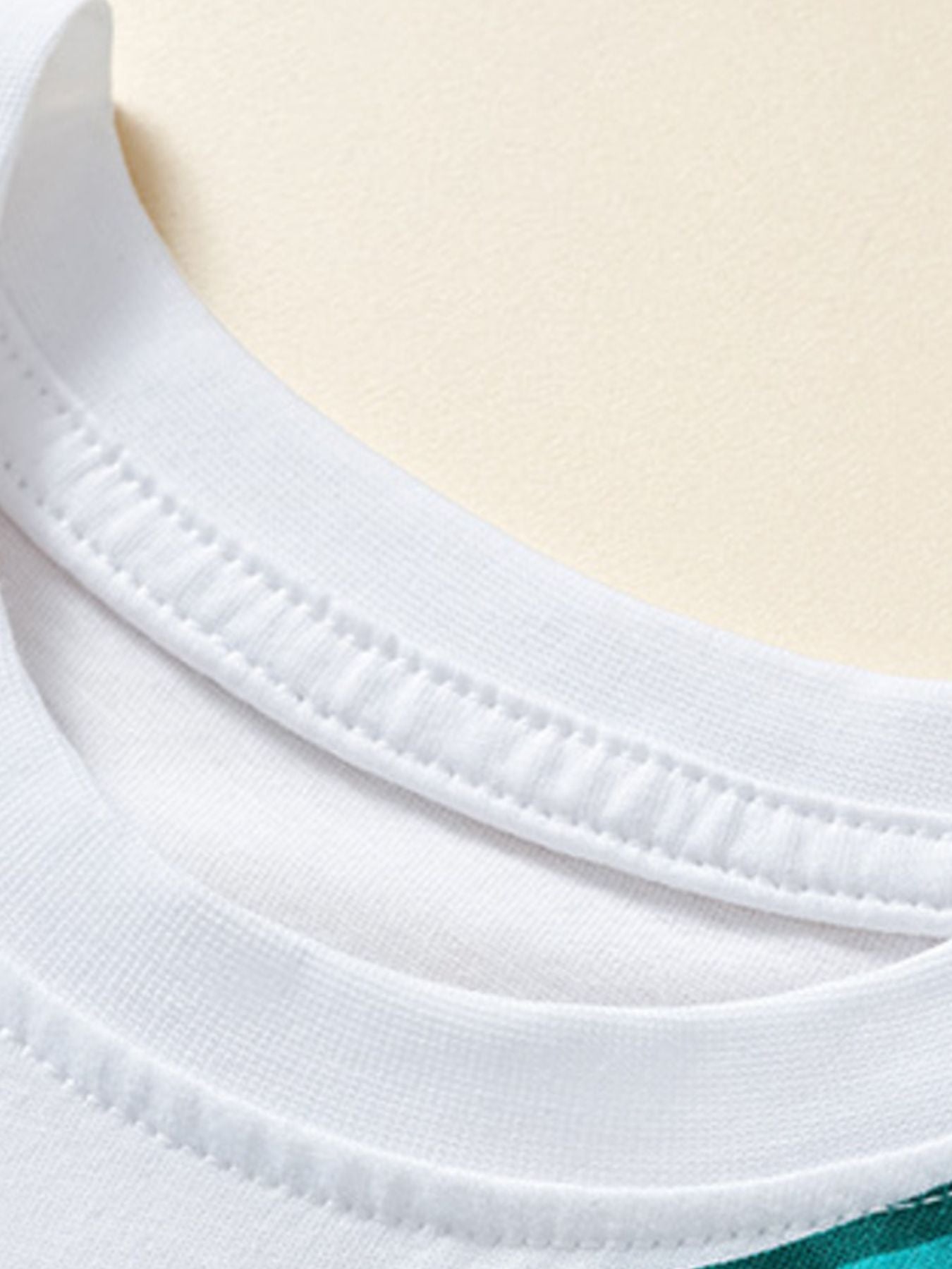White cotton toddler t-shirt neckline detail with double stitching.