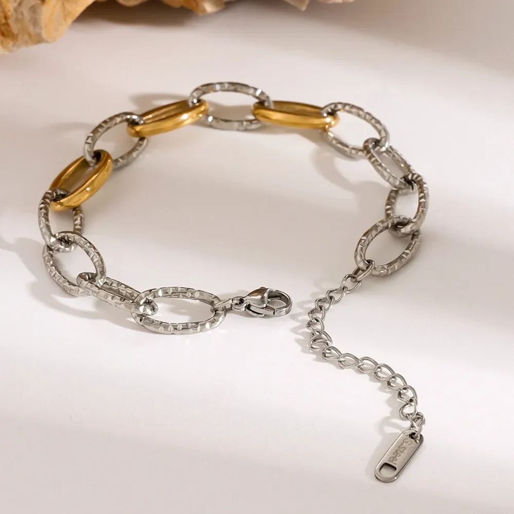Two-tone link bracelet with oval links, 18K gold-plated accents, and textured silver finish.