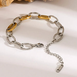 Two-tone link bracelet with oval links, 18K gold-plated accents, and textured silver finish.