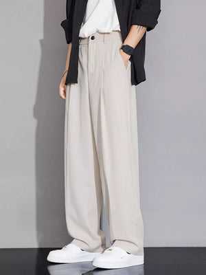 Beige wide-leg men's chinos with a relaxed fit and button closure.