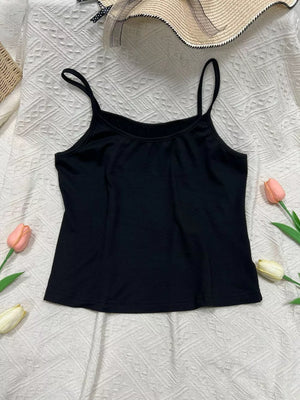 Black cami top with scoop neck and thin spaghetti straps.