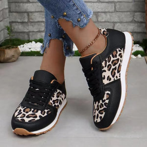 Leopard print panel runner sneakers in black with lace-up closure and white sole.