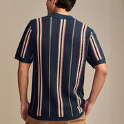 Textured stripe knit polo shirt in navy with red and beige stripes.