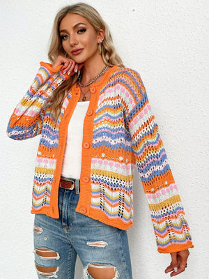 Orange knit cardigan with rainbow chevron pattern, button front, and open knit sleeves.
