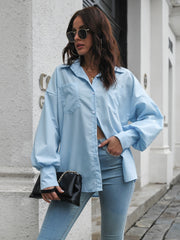 Light blue poplin button-down shirt with balloon sleeves and two chest pockets.