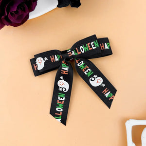 Black Halloween print bow hair clip with ghost and text detail