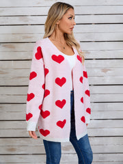 Pink acrylic cardigan with red heart intarsia pattern, open front, long sleeves.