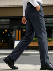 Men's dark gray classic fit dress pants with pockets, shown styled with a white dress shirt and black dress shoes.