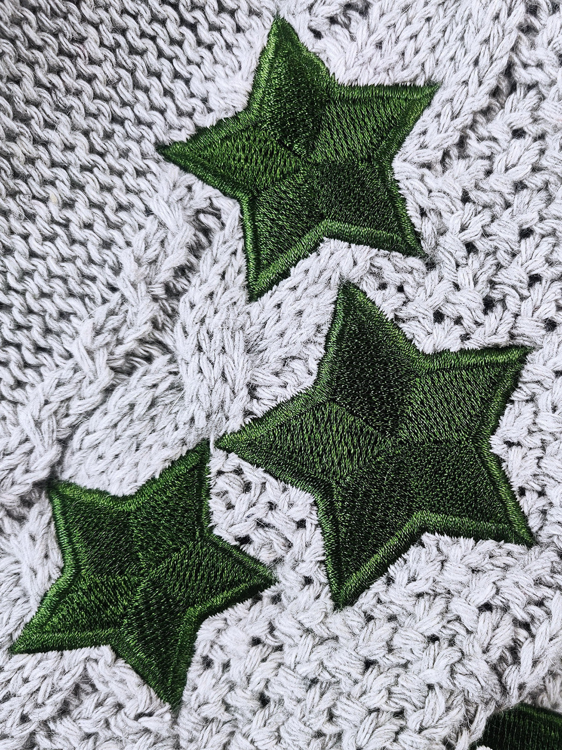 Gray cable knit cardigan with embroidered green stars detail