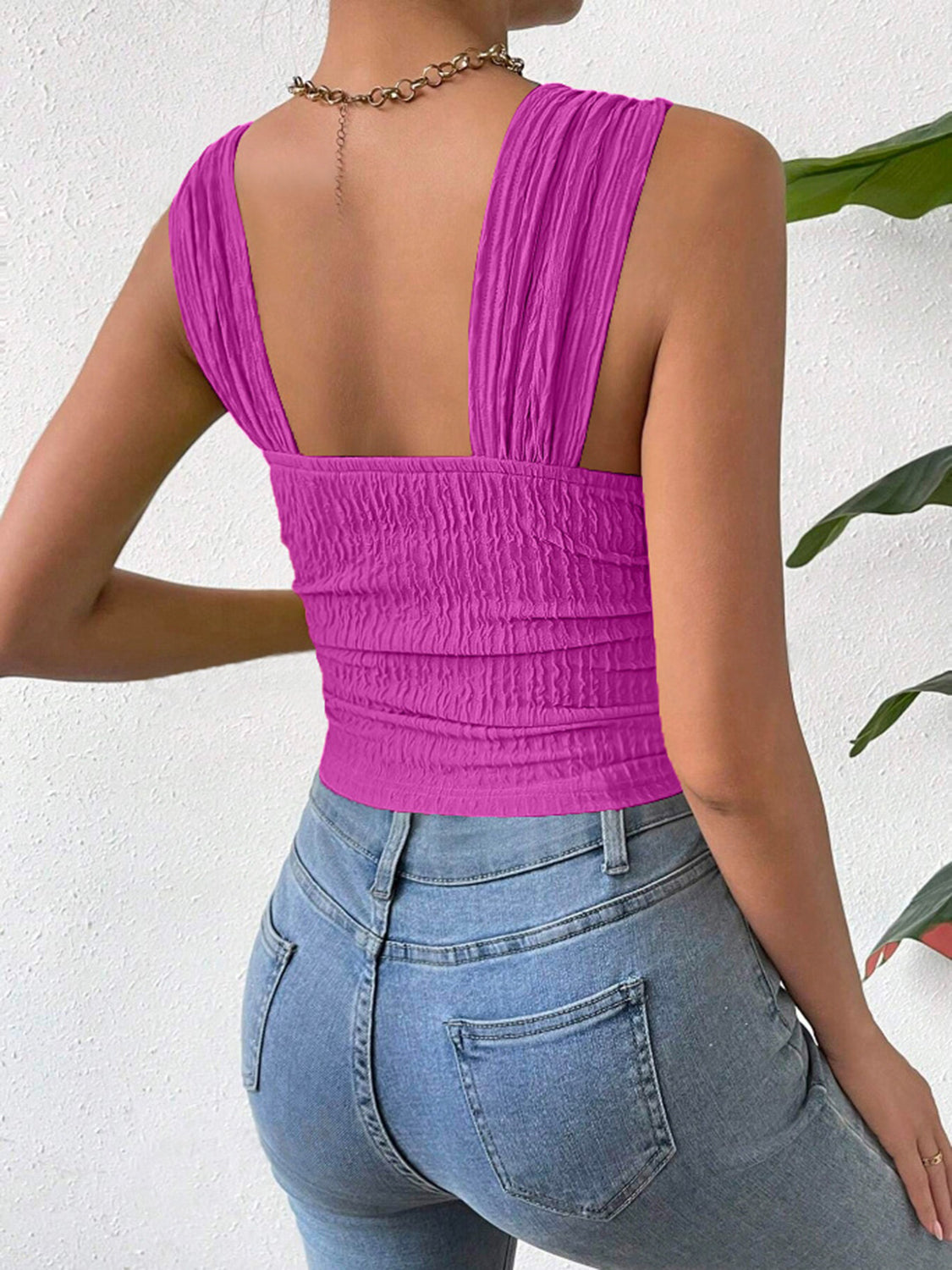 Textured crinkle strap crop top in magenta with ruched detail.