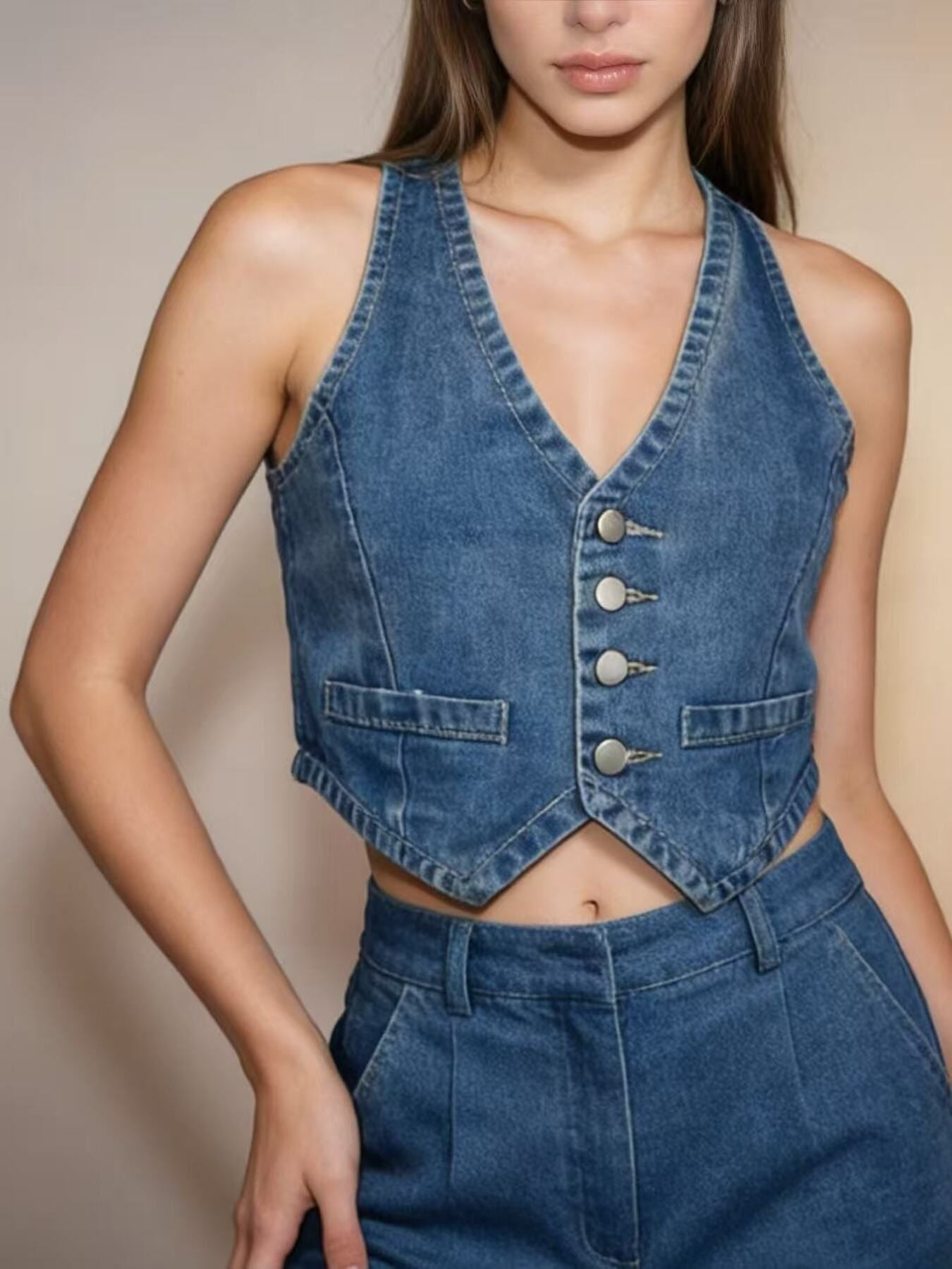 Light blue denim cropped button-down vest with V-neck and two front pockets.