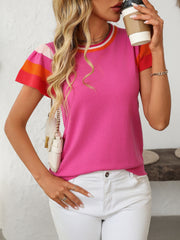 Colorblock knit top with flutter sleeves and striped neckline, in hot pink with orange and red accents.