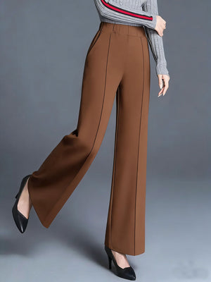 Brown high-waisted wide leg cotton trousers with pockets and front seam detail.