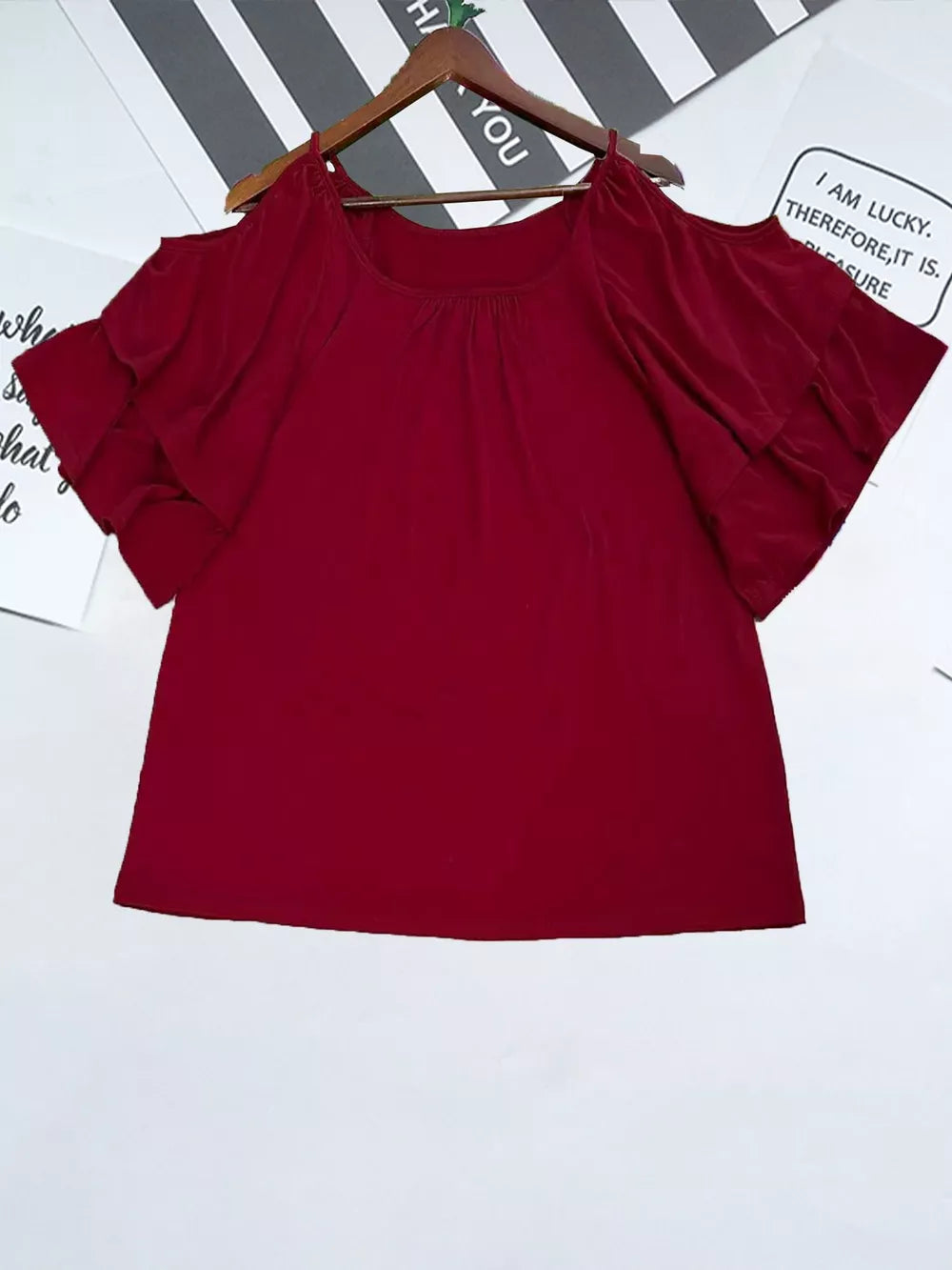 Burgundy t-shirt with gathered neckline and ruffled cold shoulder sleeves.