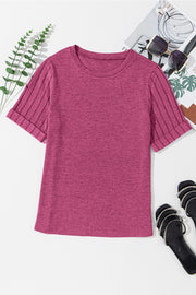 Hot pink t-shirt with ribbed short sleeves and rolled cuffs.