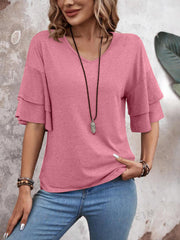 Tiered sleeve jersey tee in dusty pink with a V-neck, styled with jeans and a necklace.