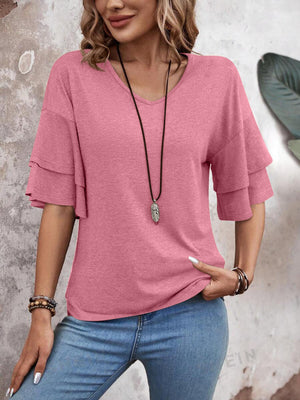 Tiered sleeve jersey tee in dusty pink with a V-neck, styled with jeans and a necklace.