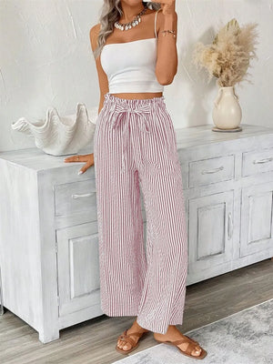 Striped paper bag maternity pants with a tie waist in Dusty Pink, styled with a white crop top.