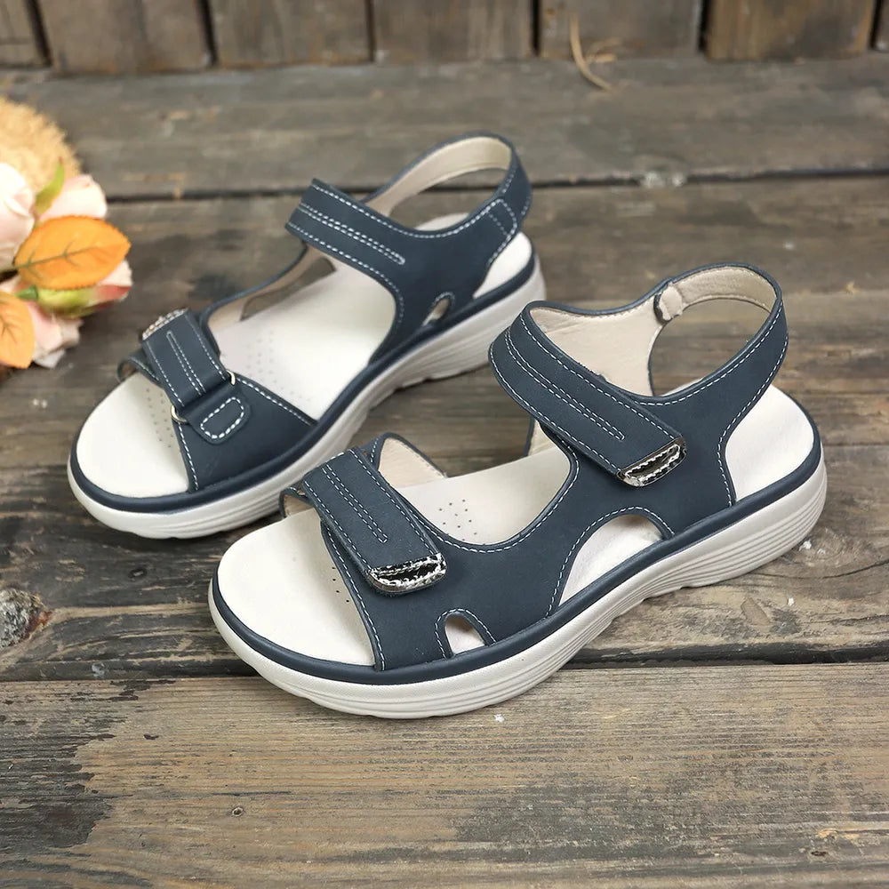Dark blue platform sandals with white contrast stitching and velcro straps.