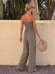 Smocked strapless olive green romper with frill detail and wide legs.