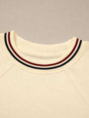 Beige cotton tunic top with a striped neckline detail and raglan sleeves.