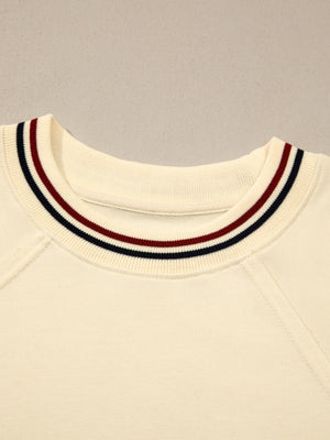 Beige cotton tunic top with a striped neckline detail and raglan sleeves.