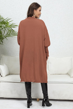 Oversized pocketed knit cardigan in caramel with a relaxed fit and long sleeves.