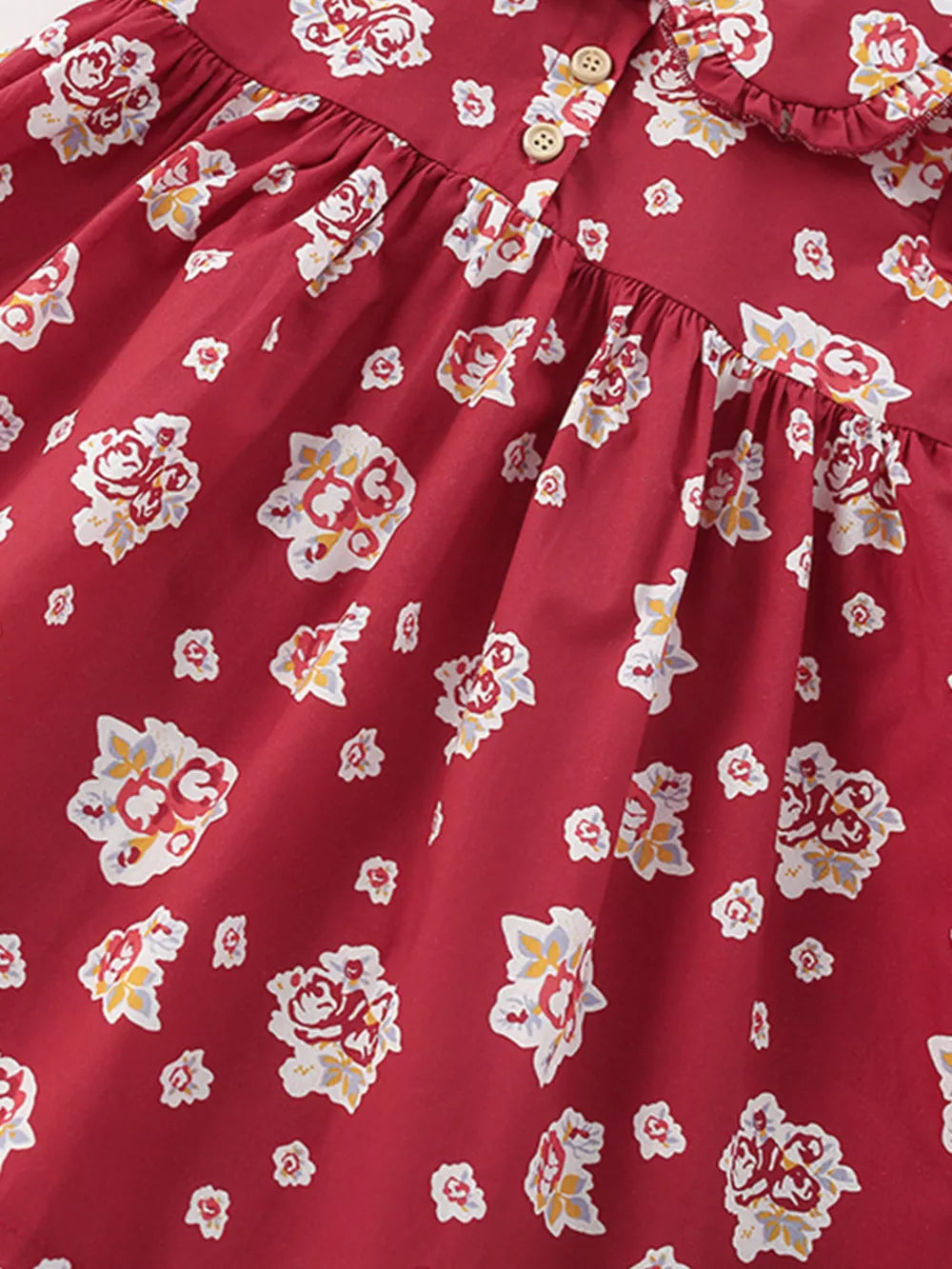 Red floral cotton baby dress with button front and ruffle collar.