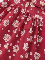 Red floral cotton baby dress with button front and ruffle collar.
