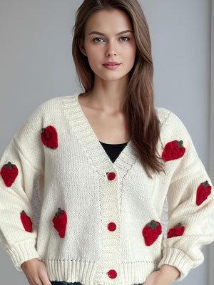 Cream knit cardigan with red strawberry appliqués and red buttons.