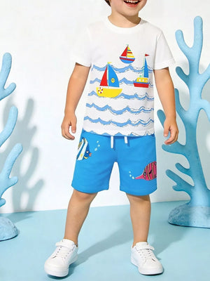 White cotton tee with sailboat print and blue shorts with fish print for boys.