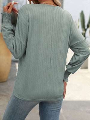 Sage textured sleeve blouson top with smocked cuffs.