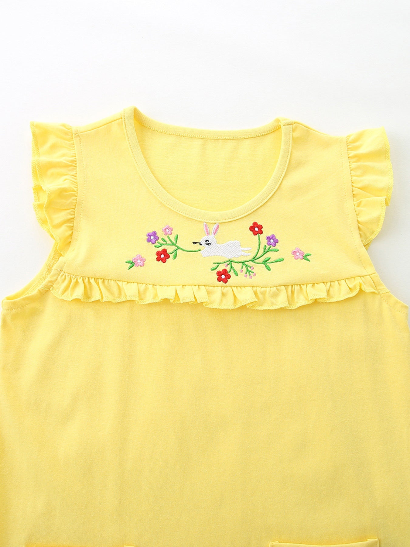 Yellow cotton toddler undershirt with ruffled sleeves and hem, featuring a bunny and floral embroidery.