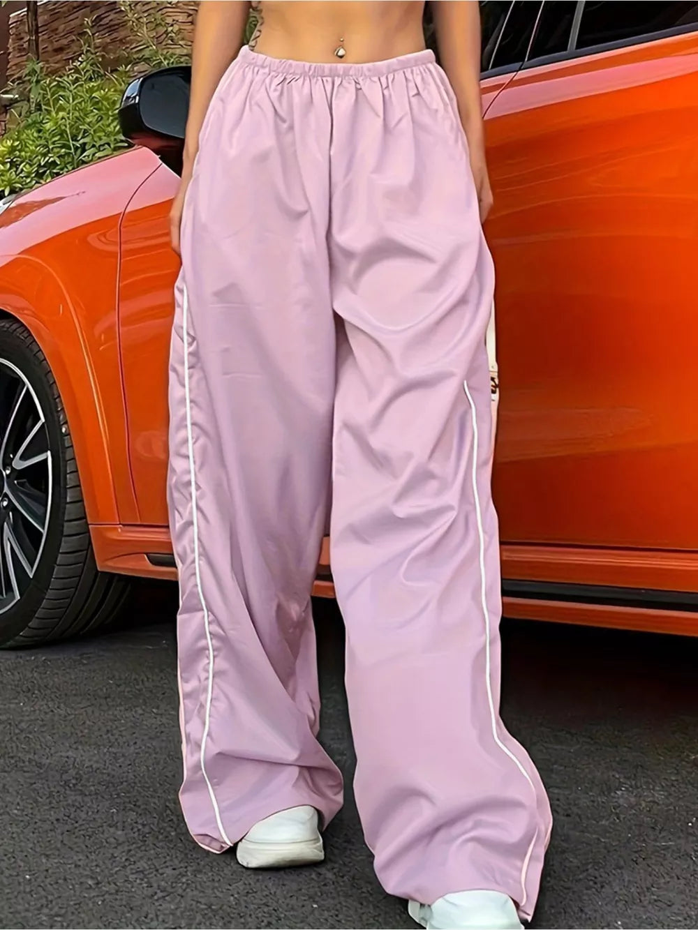 Pink wide-leg maternity pants with gathered waistband and white side stripe detail.