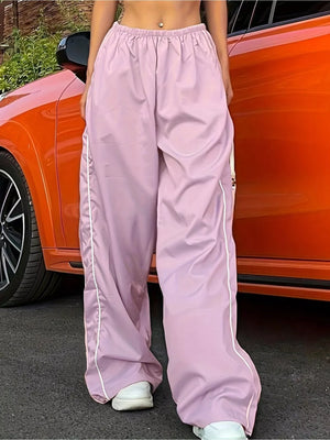 Pink wide-leg maternity pants with gathered waistband and white side stripe detail.
