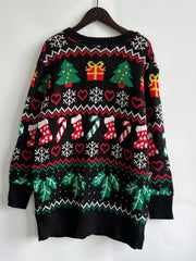 Black acrylic knit cardigan with festive Christmas pattern of trees, gifts, stockings, and snowflakes.