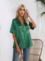 Emerald green satin collared short sleeve buttoned shirt with a relaxed fit.