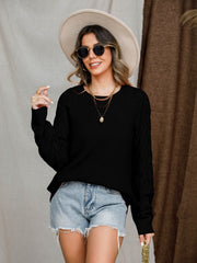 Black diamond-cut raglan knit sweater with crew neck and long sleeves.