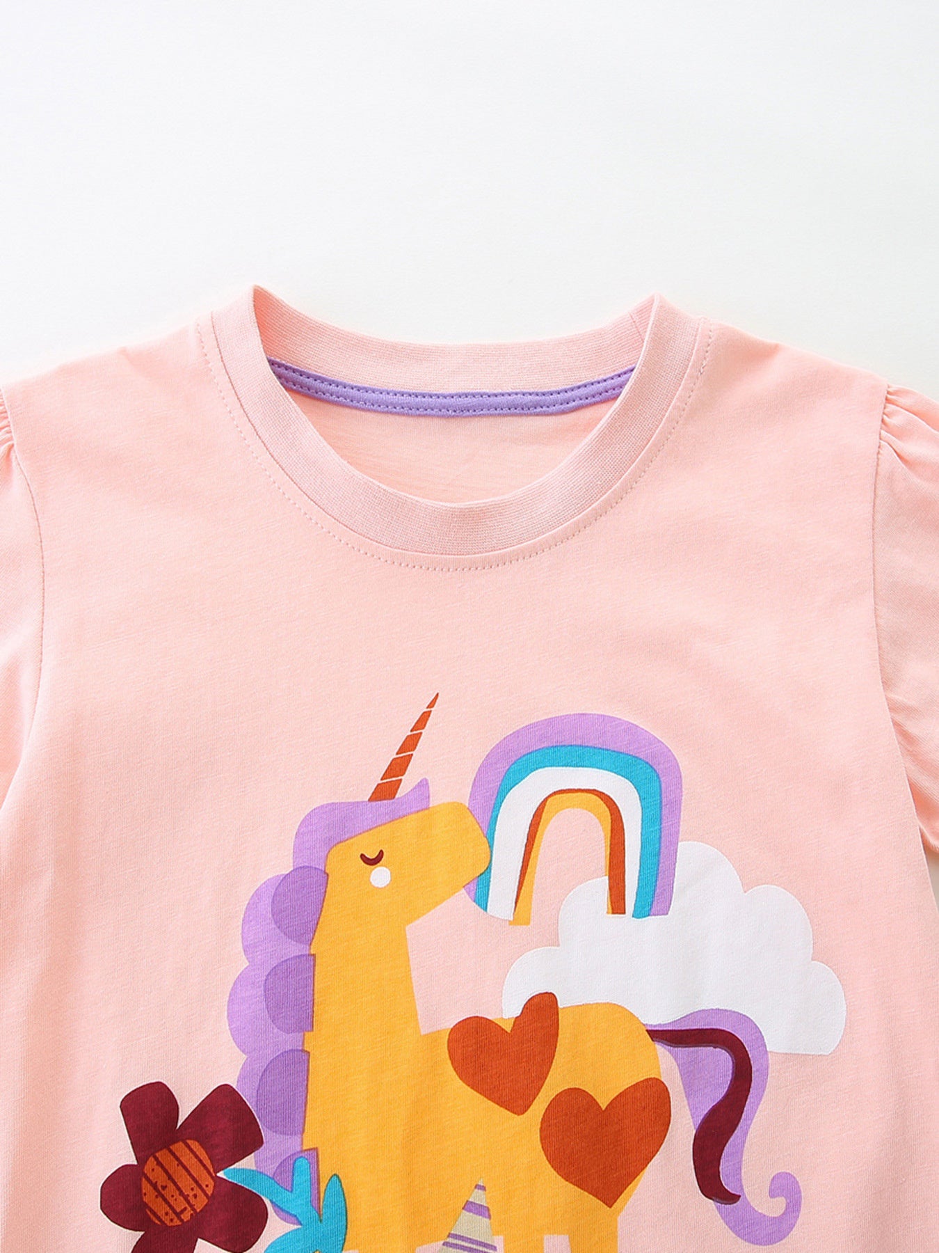 Pink cotton toddler t-shirt with unicorn, rainbow, and cloud graphic.